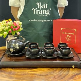 Bộ ấm chén men đen họa tiết nhành đào trắng quai đồng BT-AT32
