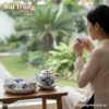 Bộ ấm trà men lam Mai Hạc Bát Tràng đặt trên bà...